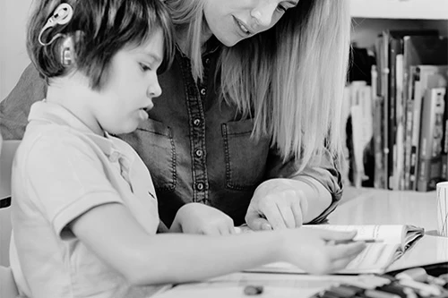 Child and mentor engaged in a hands-on science activity
